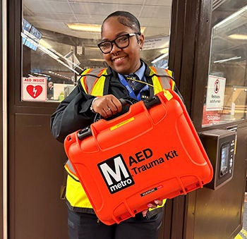 Metro employee holding AED trauma kit