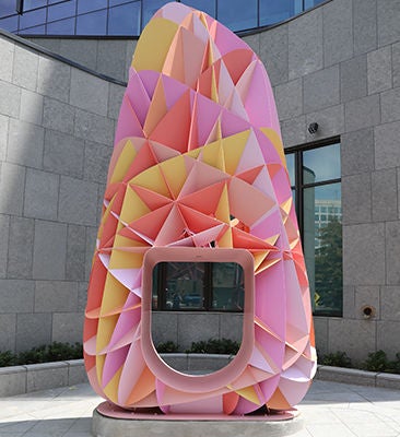 Colorful abstract sculpture in urban plaza
